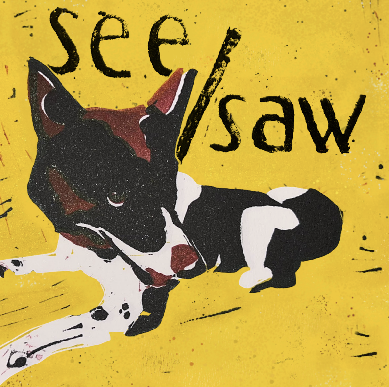 Drawn brown, white, and black dog, lying down, against a yellow background. The words "see/saw" appear above the dog.